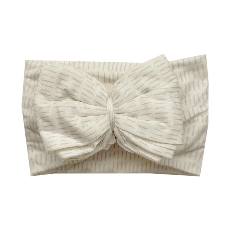 A bow-adorned Ellie - Bamboo Baby Knotted Headwrap.