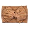 A Tiny Knot Co Nora   Bamboo Baby Knotted Headwrap with a bow on it 