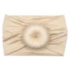 A Nora   Bamboo Baby Knotted Headwrap with a Tiny Knot Co ball on it 
