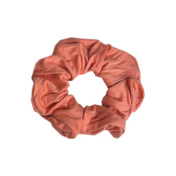 A pink scrunchie by Tiny Knot Co on a white background.