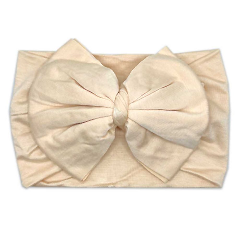 Nora - Bamboo Baby Knotted Headwrap by Tiny Knot Co, a beige headband with a bow on it.