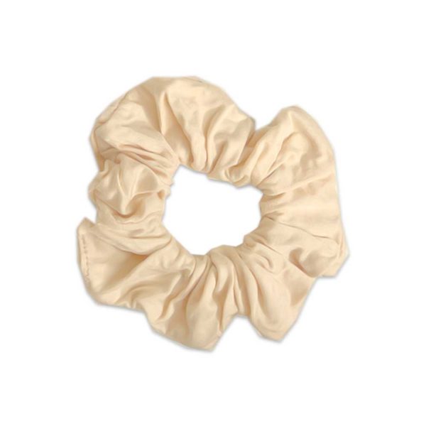 A beige scrunchie from Tiny Knot Co on a white background.