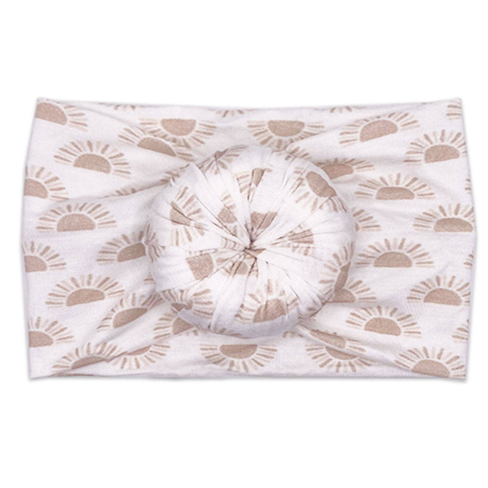 A Tiny Knot Co Sunnie - Bamboo Baby Knotted Headwrap with a sun print on it.